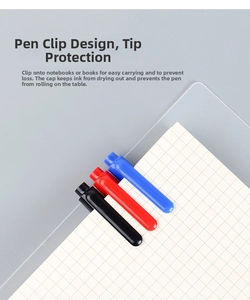 Detail of oil-based markers with pen clip and anti-roll cap design on a notebook