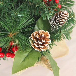 Snowy Christmas tree with red berries, pine cones and burlap base for desk decor