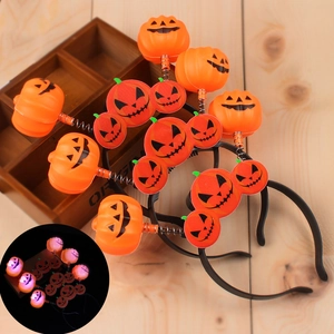Detail showing glowing LED Halloween pumpkin headbands with spring Jack-o'-lantern design