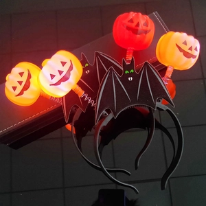 Glow-in-the-dark Halloween pumpkin and bat headbands with glittering party details