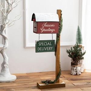 Red Christmas mailbox decor on a wooden stand with Seasons Greetings text for holiday displays