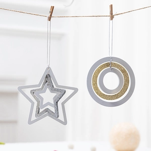 Nordic wooden star and ring Christmas ornaments in gold, silver, and white on rope