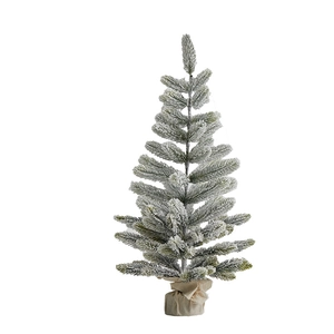 Miniature flocked tabletop Christmas tree with snowy branches and rustic burlap base