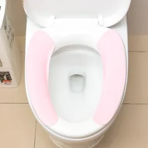 Detailed view of pink non-slip adhesive toilet seat cover pads in a two-piece set