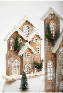 Detailed view of wooden Christmas house with artificial snow and festive red berries