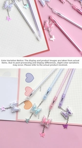 Detail of sweet butterfly pendant pens with glitter charms and macaron colored barrels