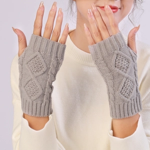 Detail of grey diamond-knit fingerless gloves with elegant cable patterns for winter