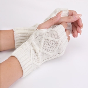 Detail of cream cable knit fingerless gloves showing diamond weave and thick texture