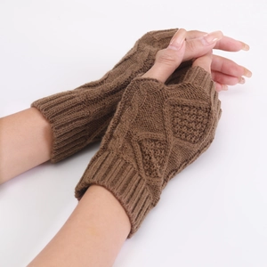 Close-up of brown diamond pattern knit fingerless gloves with ribbed cuffs and thick yarn