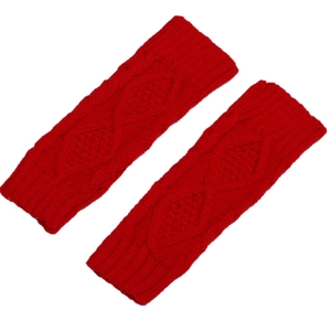 Close-up of red cable knit fingerless gloves featuring ribbed cuffs and soft cotton texture
