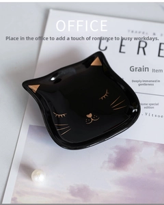 Detailed view of creative black ceramic cat plate with gold accents for jewelry or snacks