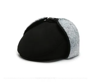Detail of winter thermal flat cap with grey flecked boucle earflaps and buckle