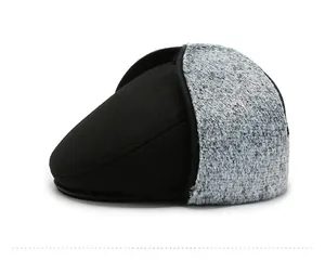 Detail view of winter duckbill cap featuring fleece ear flaps and thermal black fabric