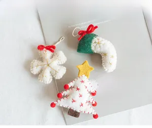 Detailed view of handmade felt Christmas ornaments including snowflake, sock and tree