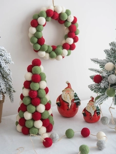 Detail of Nordic Christmas wool felt ball trees and red Santa Claus ornaments set