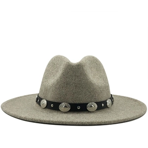 Detail of wide brim light grey wool fedora featuring black leather band and silver studs