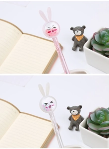 Close-up detail of cute cartoon rabbit gel pen head filled with sparkling pink sequins
