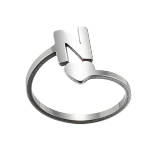 Close-up of silver stainless steel adjustable ring featuring letter N and small heart