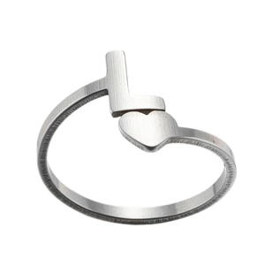 Detail view of silver stainless steel ring with brushed letter L and heart design