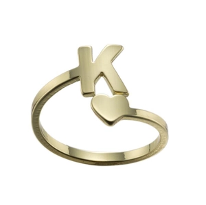 Detailed close-up of gold ring with letter K and heart charm on white background