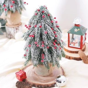 Desktop snowy Christmas tree with red berries and burlap base for holiday decor