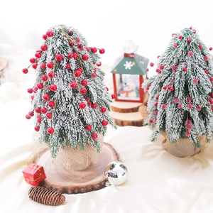 Mini tabletop snowy Christmas tree with red berries and burlap base for festive decor