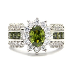 Macro shot of a silver ring with olive green oval gem and white zircon accents