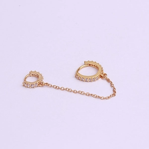 Detail of gold chain connected double hoop earrings with sparkling cubic zirconia accents