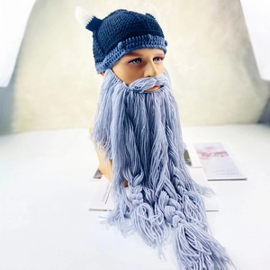 Detailed knit texture of viking pirate beanie with horns and braided grey beard mask