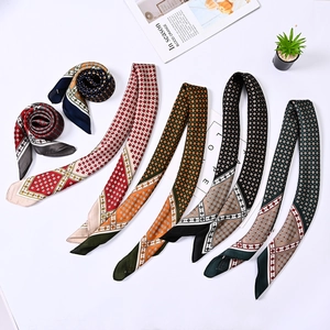 Flat lay of silk scarves with geometric and chain patterns in diverse color palettes
