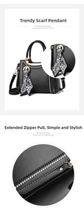 Detail of black tote bag featuring contrast stitching, metal zipper and leopard scarf charm