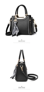 Detail of black tote bag with white zigzag stitching and leopard print silk scarf handle