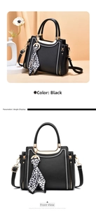 Detail of black tote bag with white contrast stitching and leopard print silk scarf charm