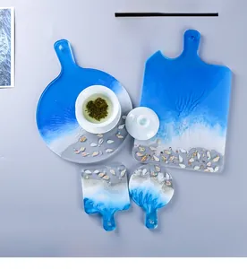 Detailed top view of DIY ocean resin wave coasters with shells and pearls decor