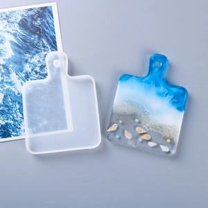 Detail showing silicone tray mold and ocean resin finished piece with shells and glitter