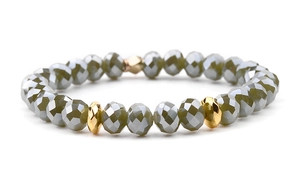 Detailed shot of grey faceted crystal beads and gold metal spacers on elastic bracelet