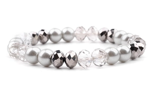 Detailed shot of elastic bead bracelet with grey imitation pearls and faceted crystals