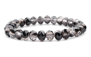 Detail of faceted glass beads on a black and grey gradient crystal stretch bracelet