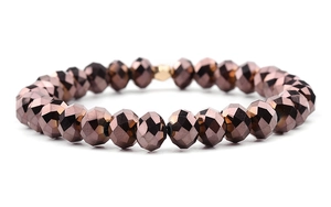 Close-up of metallic brown faceted glass beads with gold accent bead on elastic bracelet