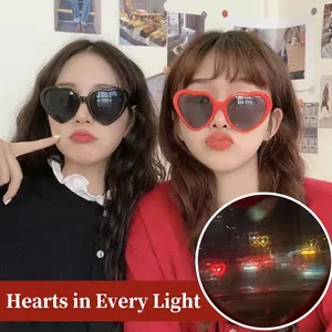 Heart-shaped effect sunglasses in black and red frames with romantic light diffraction