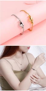 Detail view of double-layer heart necklace and bracelet set in silver and gold finishes