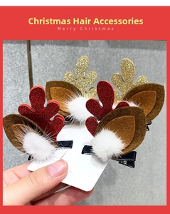 Detail of Christmas reindeer antler hair clips with red and gold glitter and faux fur