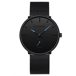 Detailed macro view of black mesh metal strap and minimalist quartz watch dial with blue hands