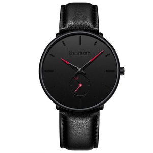 Close-up of minimalist black men's watch with red hands and textured leather strap