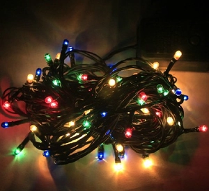 Multicolor LED Christmas string lights with black wire and controller for holiday tree decor