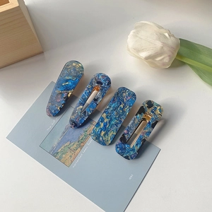 Detail view of 4-piece acrylic hair clips set with oil painting marble texture and chic colors