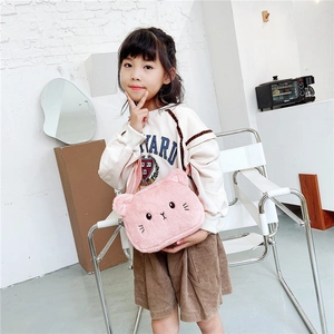 Pink plush cat crossbody bag for girls with embroidered details worn by a young model