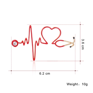 Creative red stethoscope brooch with heart rate line and rhinestone on white background