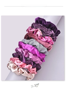 Detail of 9-piece assorted velvet and satin scrunchies set with rich textures and colors