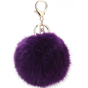 Detailed close-up of a plush dark purple faux fur keychain with a gold lobster clasp